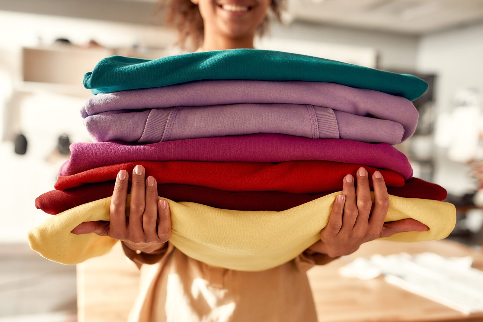 Stack of colorful custom hoodies